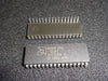 Two AMD microprocessors on a dark textured surface