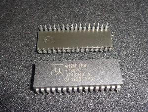 Two AMD microprocessors on a dark textured surface