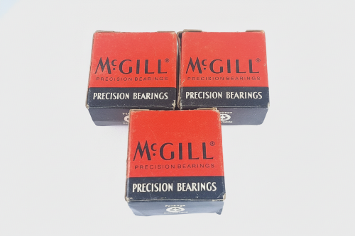 BACB10BH59F6 Three boxes of McGill precision bearings on a light gray background