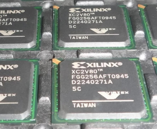 Xilinx chips with visible model numbers and branding on a metallic surface
